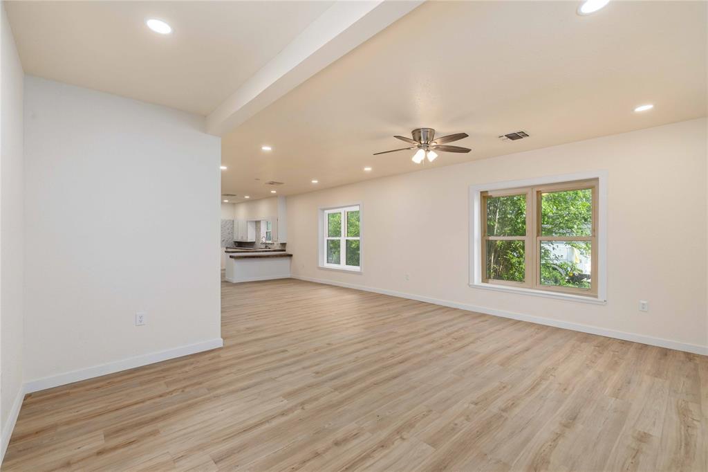516 South Pecos Street Coleman, TX 76834 - Photo 4 of 32 wooden floor in an empty room with a window