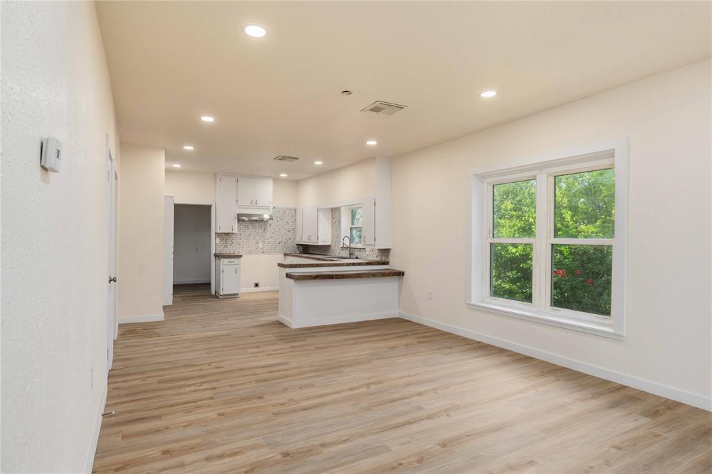 516 South Pecos Street Coleman, TX 76834 - Photo 7 of 32 a view of kitchen with wooden floor and electronic appliances