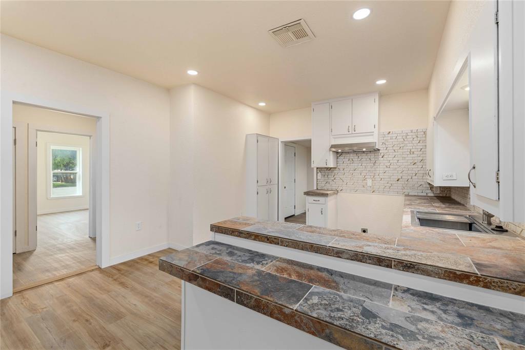 516 South Pecos Street Coleman, TX 76834 - Photo 10 of 32 a view of a kitchen with kitchen island a sink stainless steel appliances and cabinets