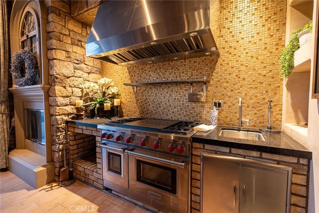 a kitchen with counter top space appliances and windows