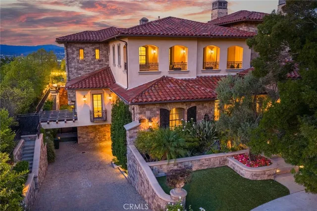 a view of a dining room with furniture a chandelier and wooden floor