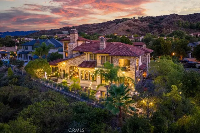 a view of a patio with couches table and chairs and potted plants
