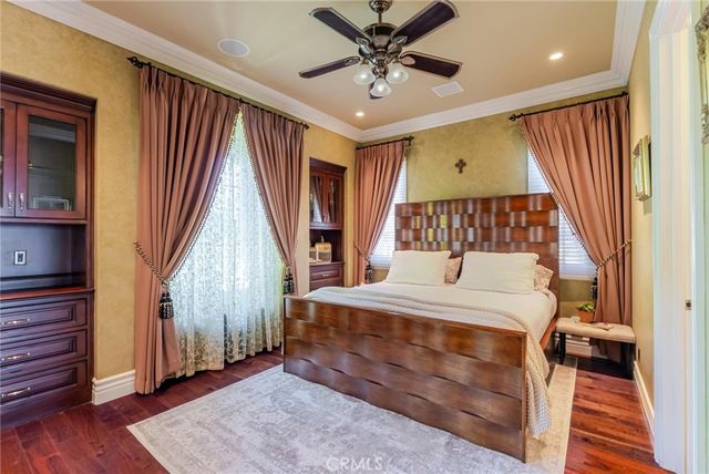 a spacious bathroom with a granite countertop double vanity and a bathtub