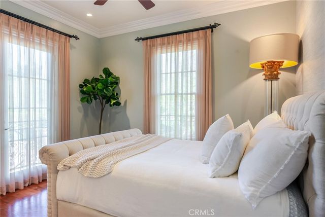 a bedroom with a large bed and a chandelier