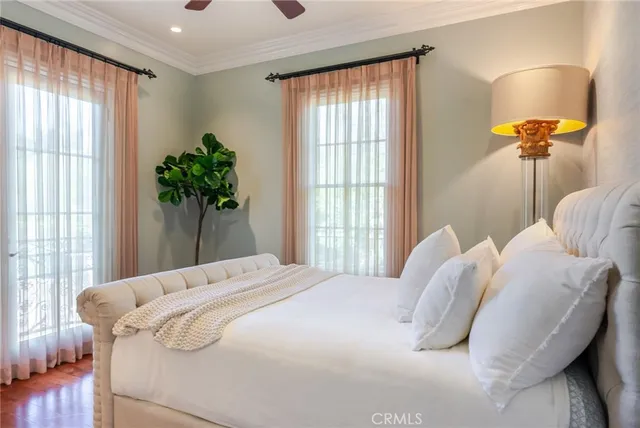 a bedroom with a large bed and a chandelier