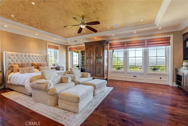 a living room with furniture a flat screen tv and a large window