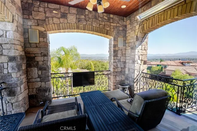 a living room with furniture a chandelier and a window
