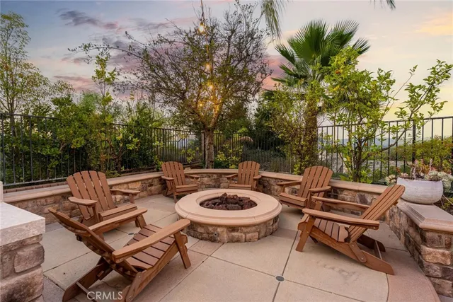 a view of a patio with couches and table and chairs and potted plants