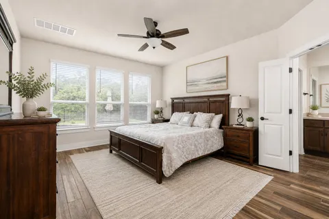 a bedroom with a large bed and a window