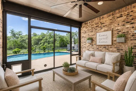 a living room with furniture and a floor to ceiling window