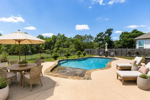 a view of a swimming pool with a lounge chairs