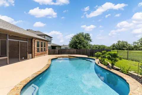 a view of a house with swimming pool and sitting area