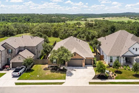 an aerial view of a house with garden space and ocean view