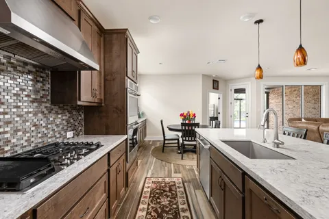 a kitchen with sink stove and cabinets