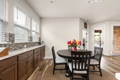 a dining room with furniture and window