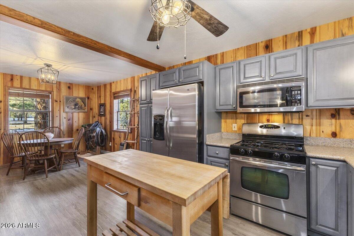 24 County Road 2065 Alpine, AZ 85920 - Photo 11 of 32 a kitchen with stainless steel appliances kitchen island granite countertop a stove refrigerator and cabinets