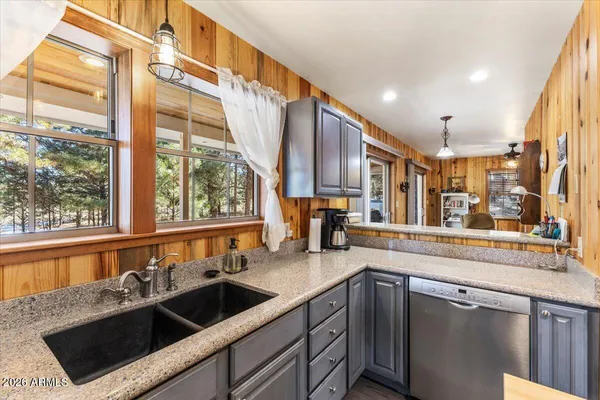 a kitchen with stainless steel appliances a refrigerator and a stove top oven