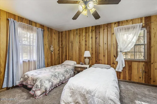 a spacious bedroom with a bed and a window