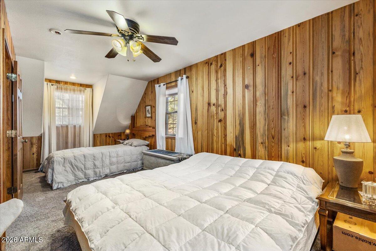 24 County Road 2065 Alpine, AZ 85920 - Photo 21 of 32 a bedroom with a bed and a chandelier
