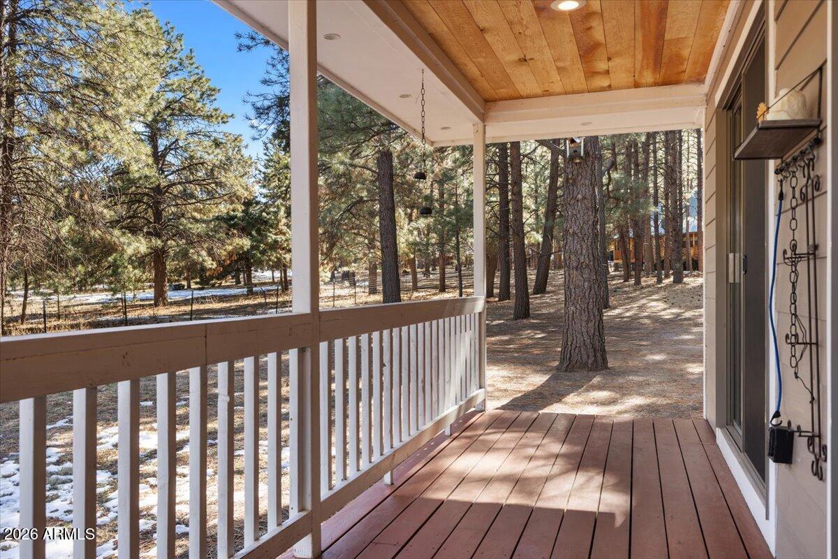 24 County Road 2065 Alpine, AZ 85920 - Photo 22 of 35 a view of a porch with wooden floor and floor to ceiling window