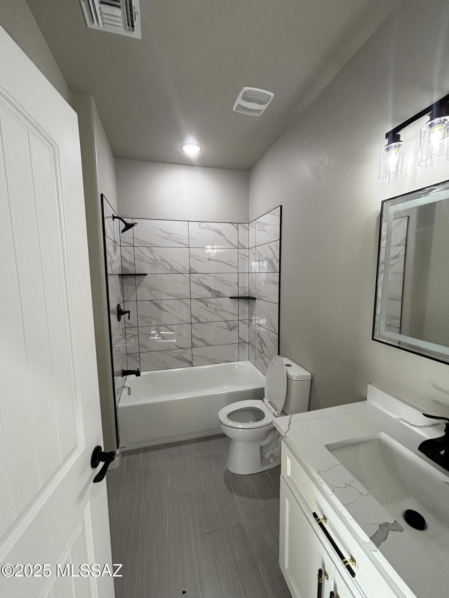 233 Canasta Court Rio Rico, AZ 85648 - Photo 5 of 10 a bathroom with a sink toilet and shower