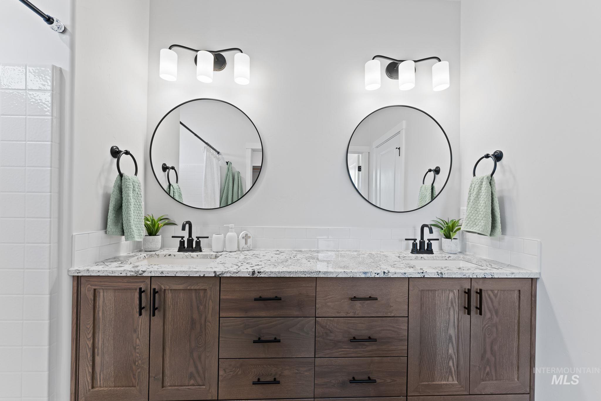 2220 Great Basin Way Burley, ID 83318 - Photo 23 of 39 Bathroom featuring double vanity and a shower with curtain