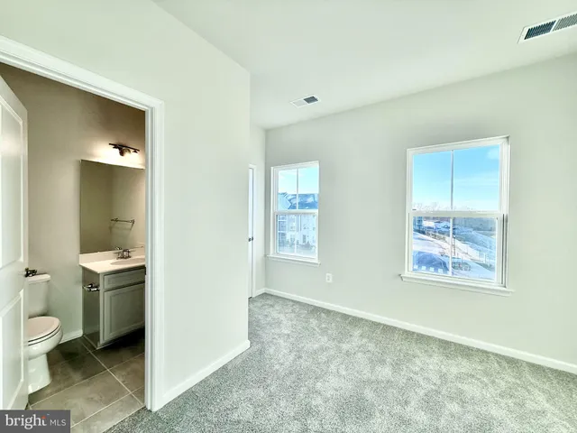a bathroom with a toilet sink and shower