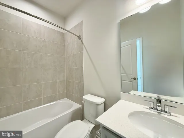 a bathroom with a sink a toilet and a bathtub