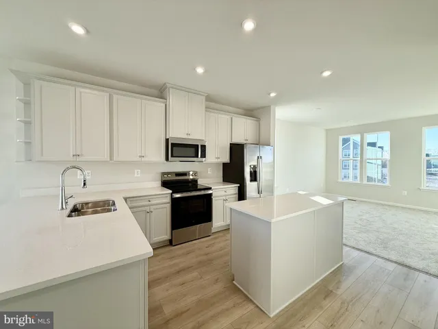 a kitchen with cabinets and stainless steel appliances