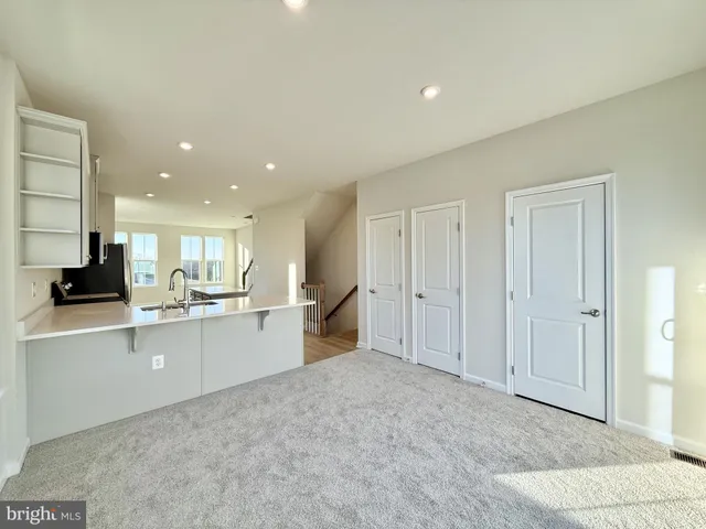 a large white kitchen with a sink