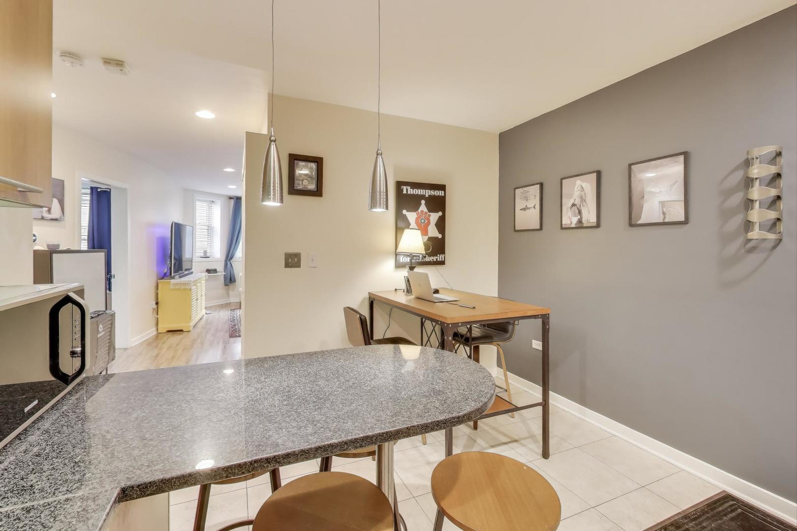 1655 North Fairfield Avenue, Unit 102 Chicago, IL 60647 - Photo 13 of 17 a view of a dining room with furniture and a potted plant