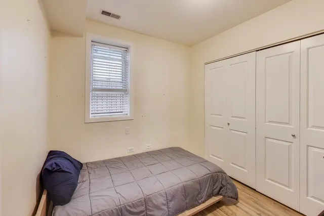 a bedroom with a bed and a window