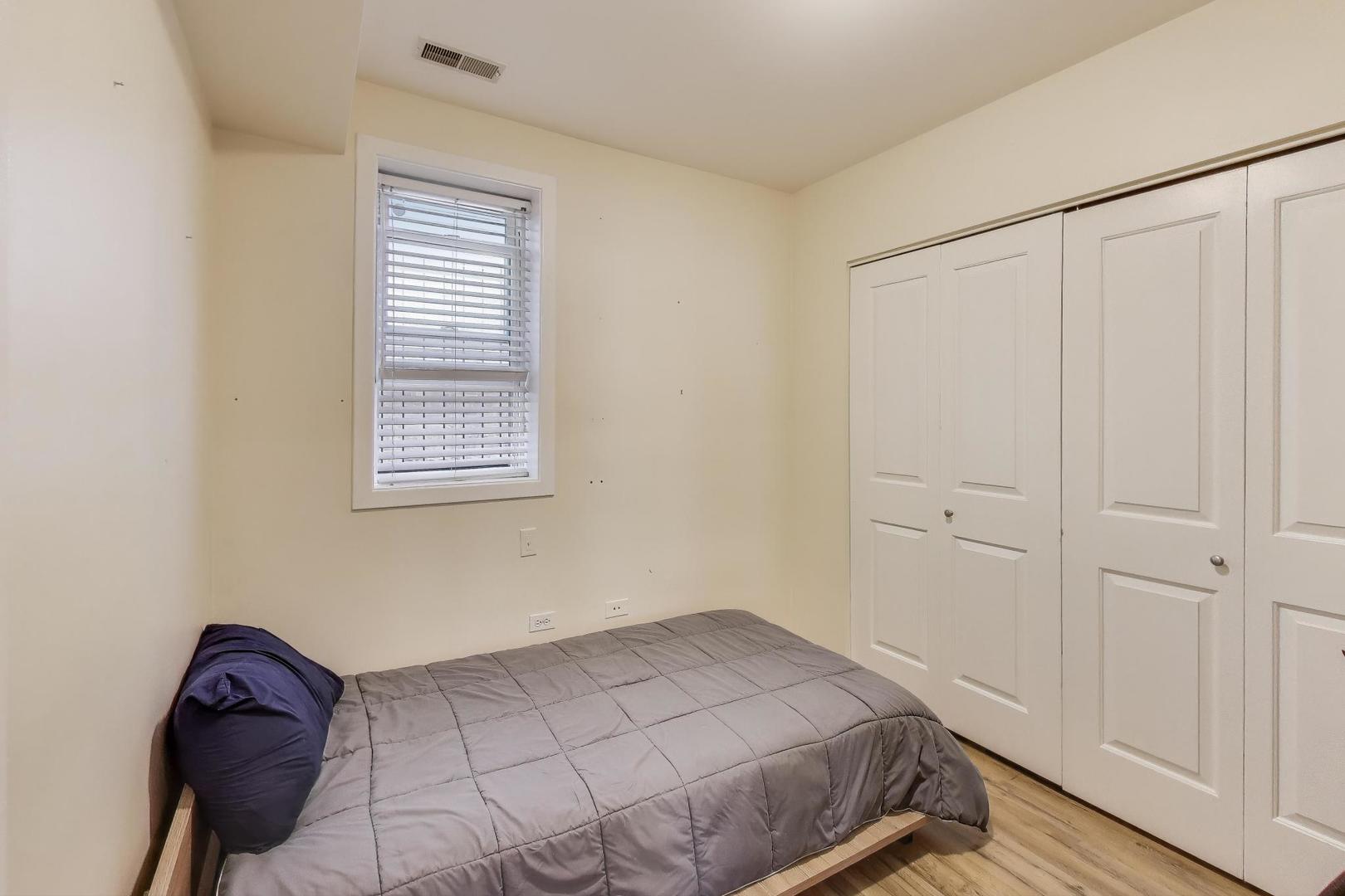 1655 North Fairfield Avenue, Unit 102 Chicago, IL 60647 - Photo 15 of 17 a bedroom with a bed and a window