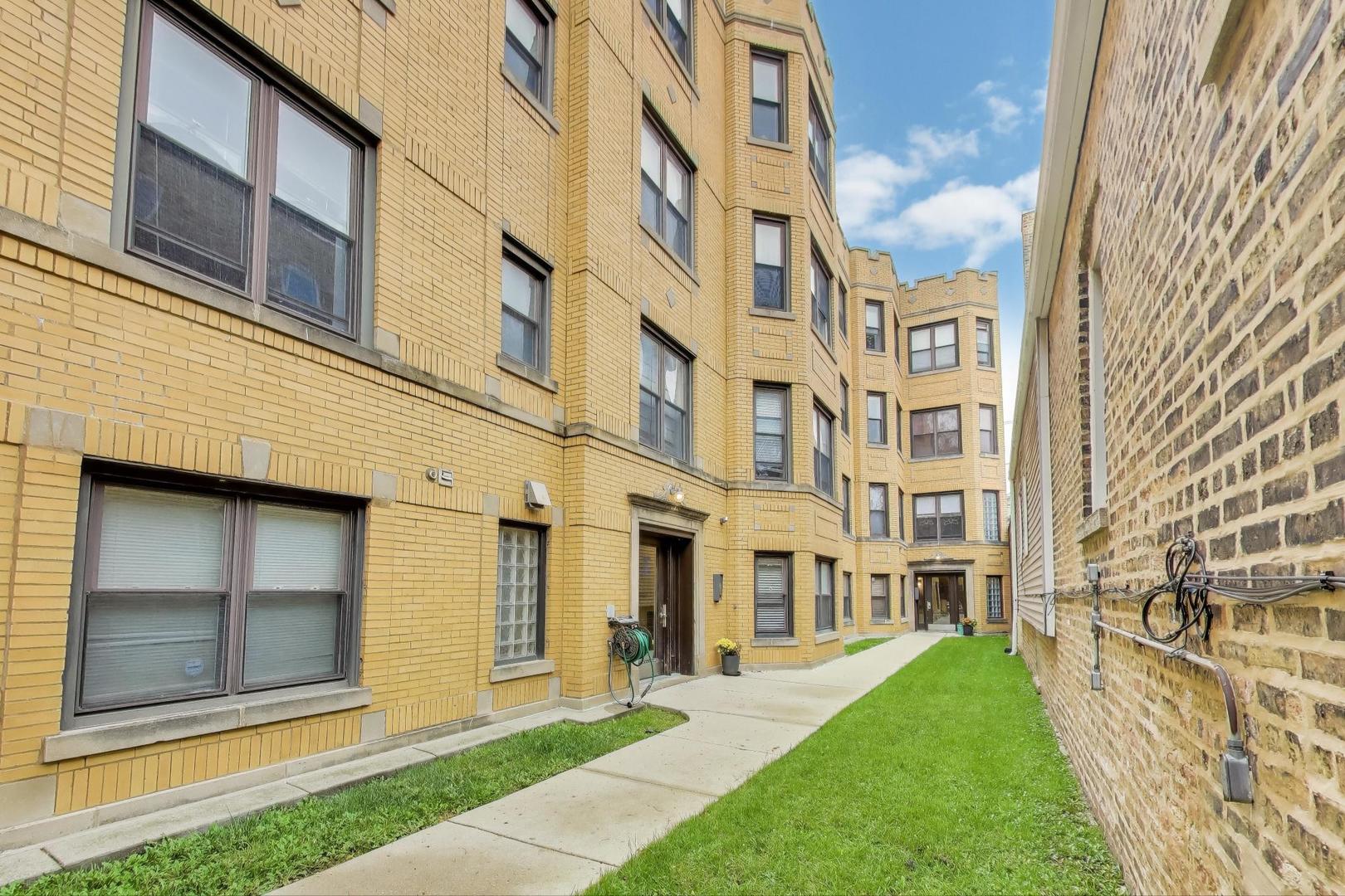 1655 North Fairfield Avenue, Unit 102 Chicago, IL 60647 - Photo 2 of 17 a view of a building with a yard
