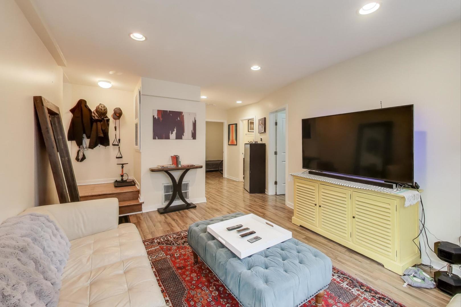 1655 North Fairfield Avenue, Unit 102 Chicago, IL 60647 - Photo 5 of 17 a living room with furniture and a flat screen tv