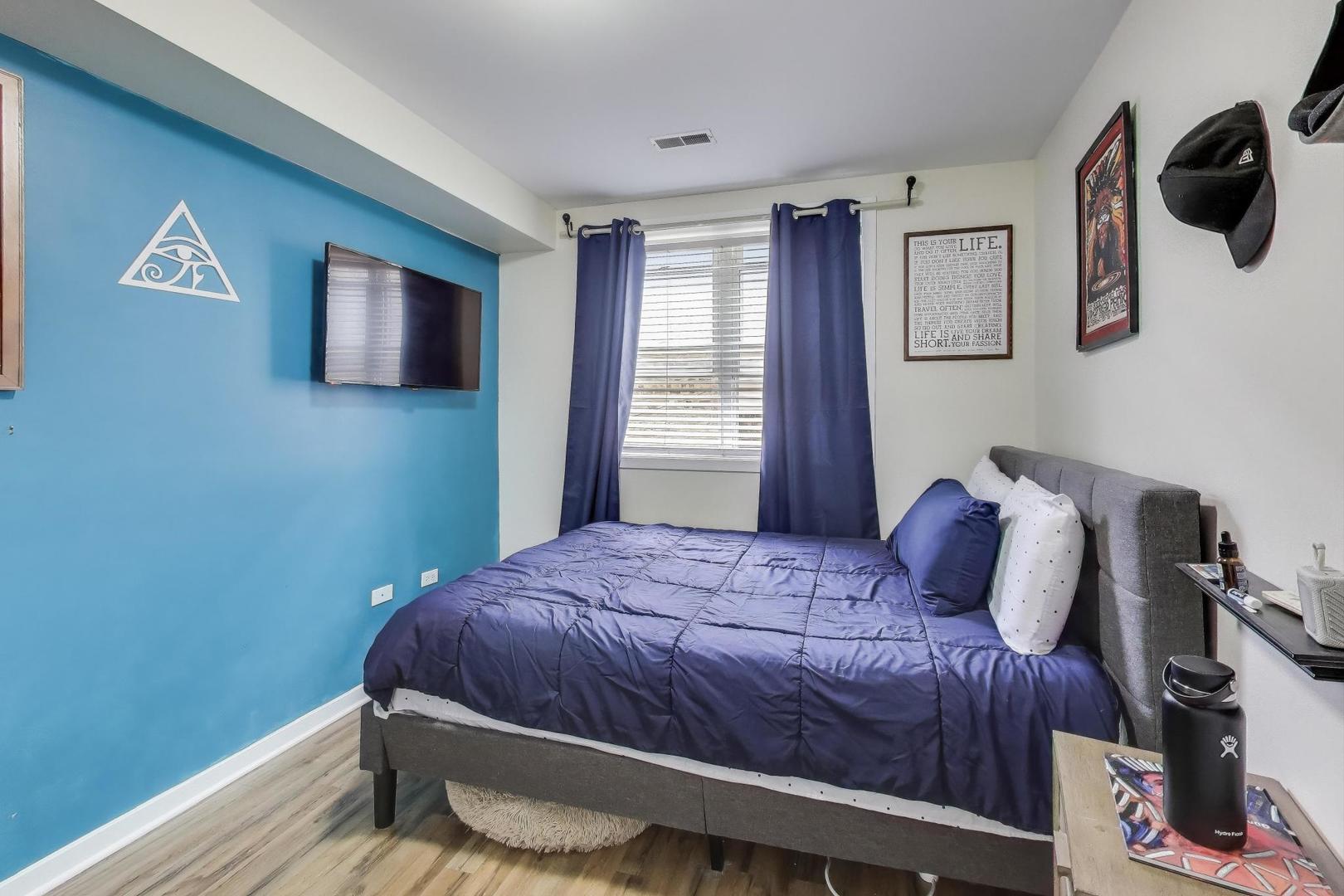 1655 North Fairfield Avenue, Unit 102 Chicago, IL 60647 - Photo 10 of 17 a bedroom with a bed and wooden floor