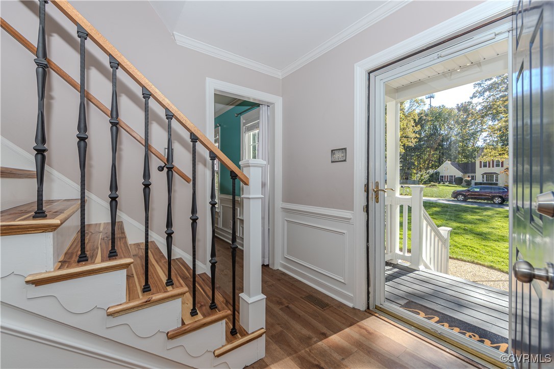 Come in! Solid hardwood flooring, updated newel po