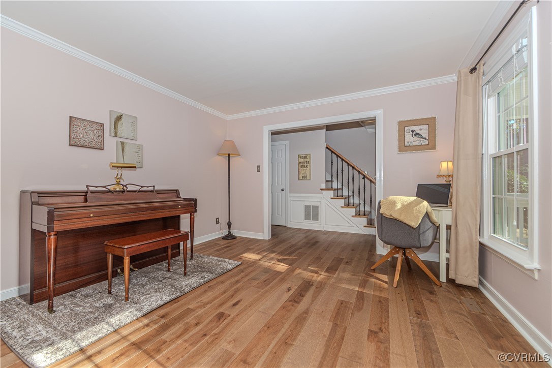 Living room featuring ornamental molding and solid