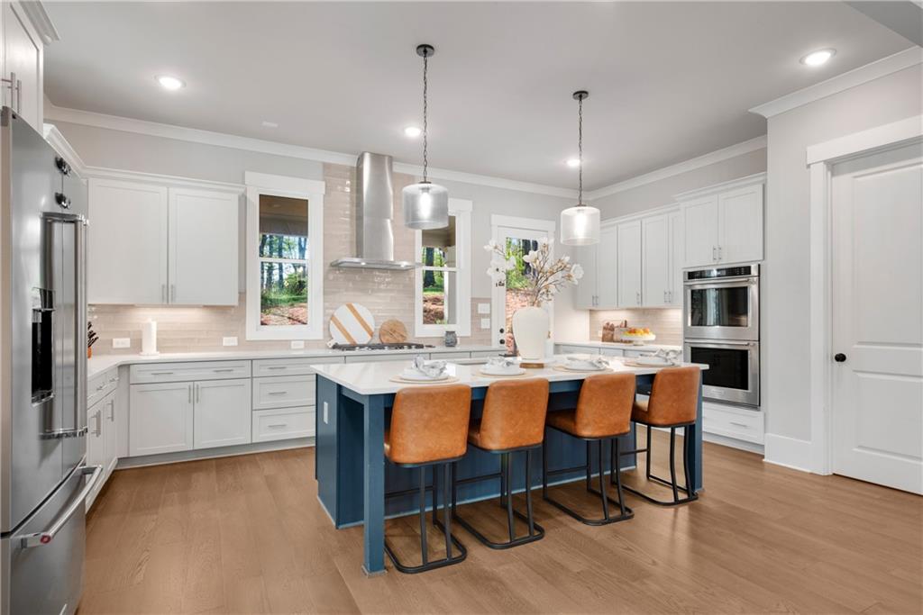 1 Ewing Way Dacula, GA 30019 - Photo 15 of 50 a kitchen with center island table and chairs in it