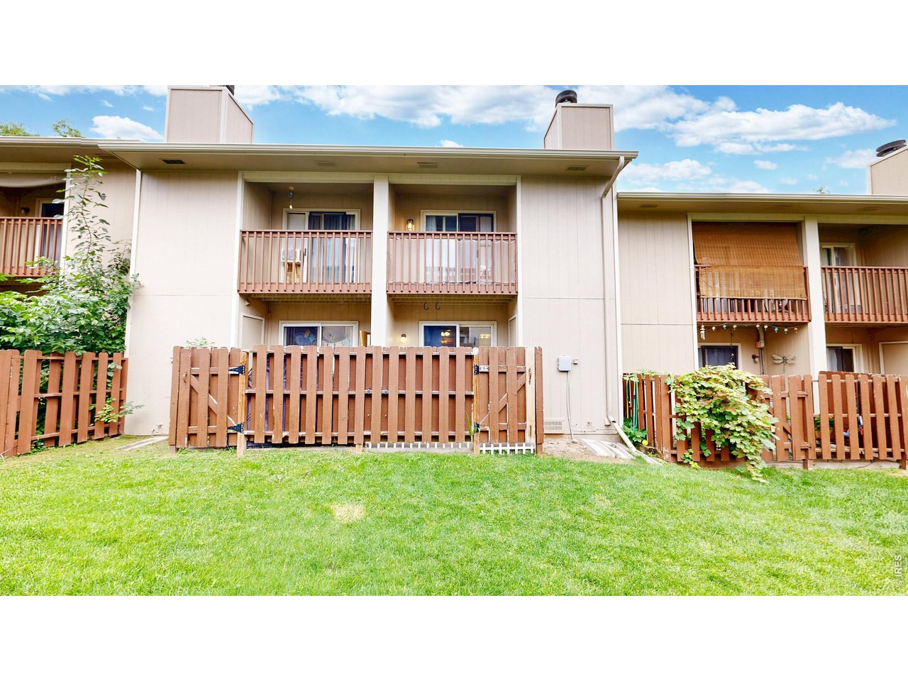 1440 Edora Road, Unit 19 Fort Collins, CO 80525 - Photo 23 of 30 The private back patio and second-story balcony, framed by shared green space