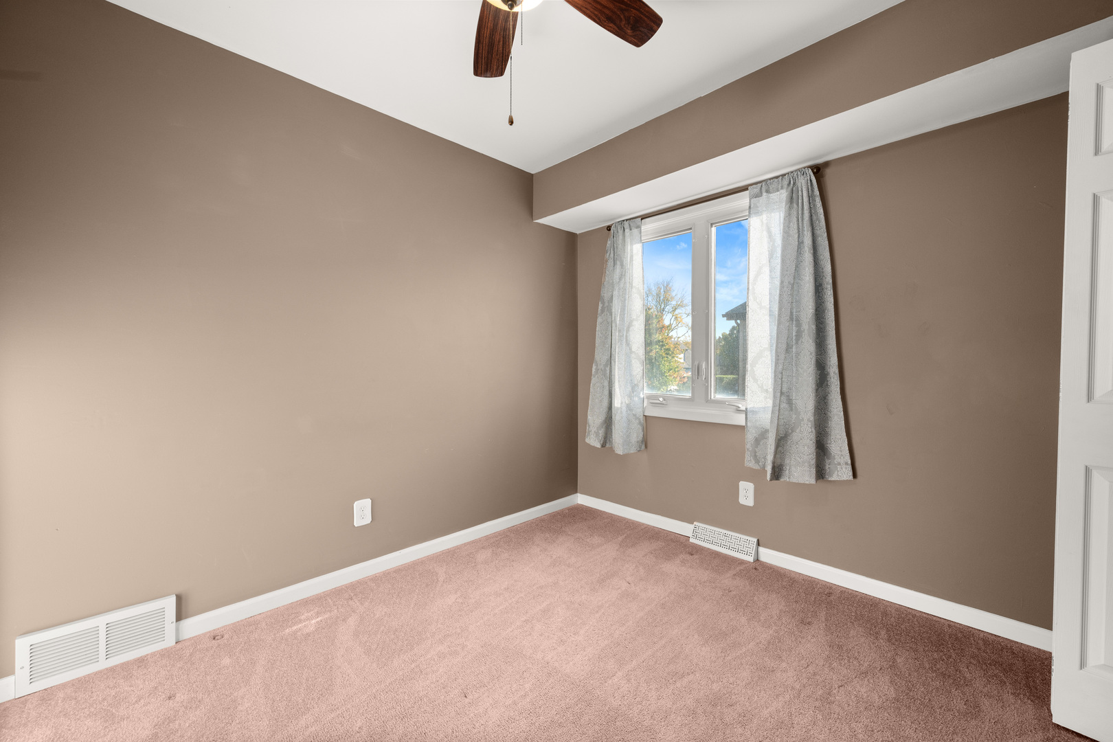 1721 Cedarbrook Court, Unit 1 Sycamore, IL 60178 - Photo 12 of 18 an empty room with windows and fan