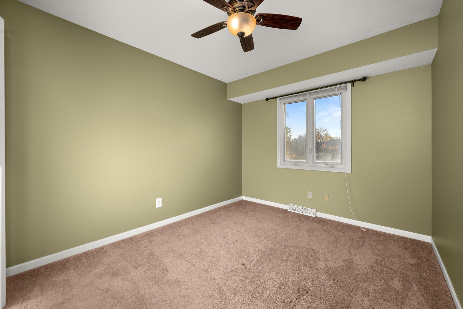 1721 Cedarbrook Court, Unit 1 Sycamore, IL 60178 - Photo 13 of 18 an empty room with a window and a fan