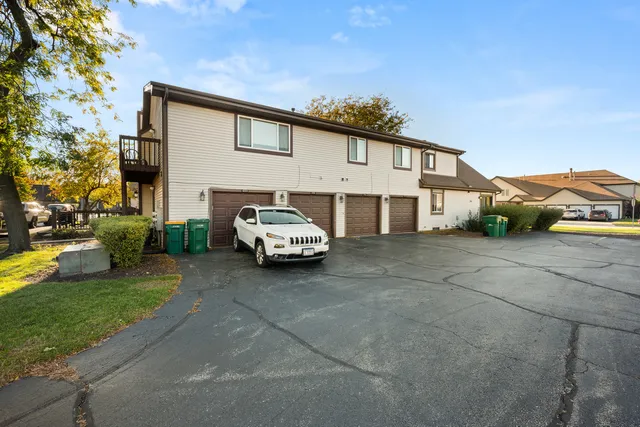 a white house covered with tall trees