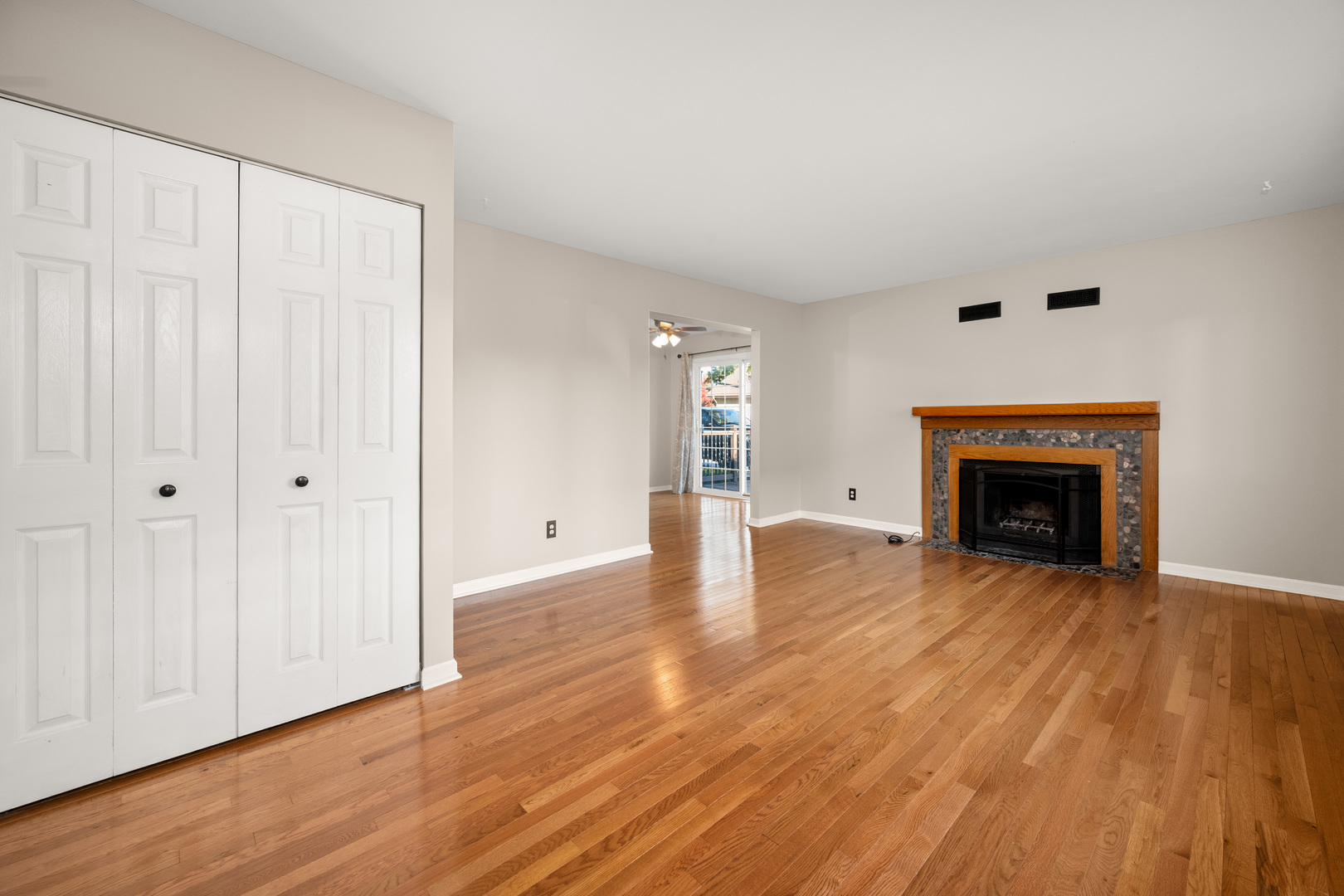 1721 Cedarbrook Court, Unit 1 Sycamore, IL 60178 - Photo 5 of 18 an empty room with wooden floor fireplace and windows
