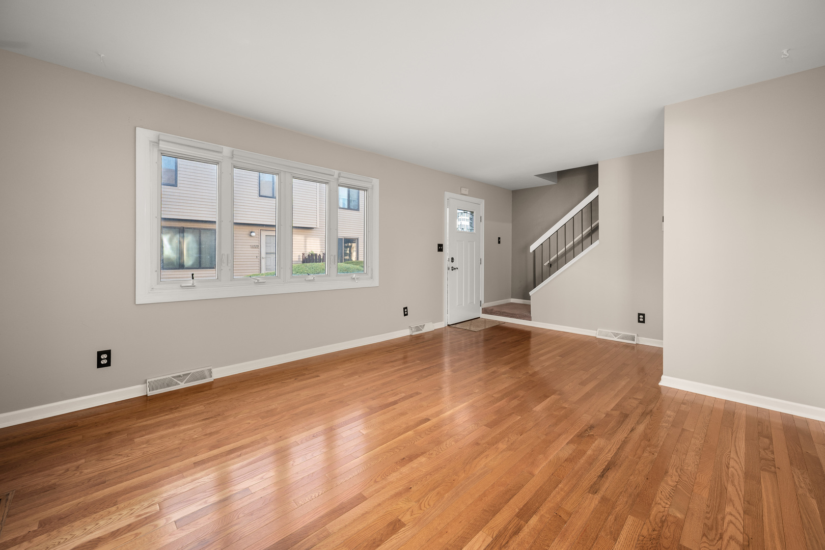 1721 Cedarbrook Court, Unit 1 Sycamore, IL 60178 - Photo 6 of 18 a view of empty room with wooden floor and fan