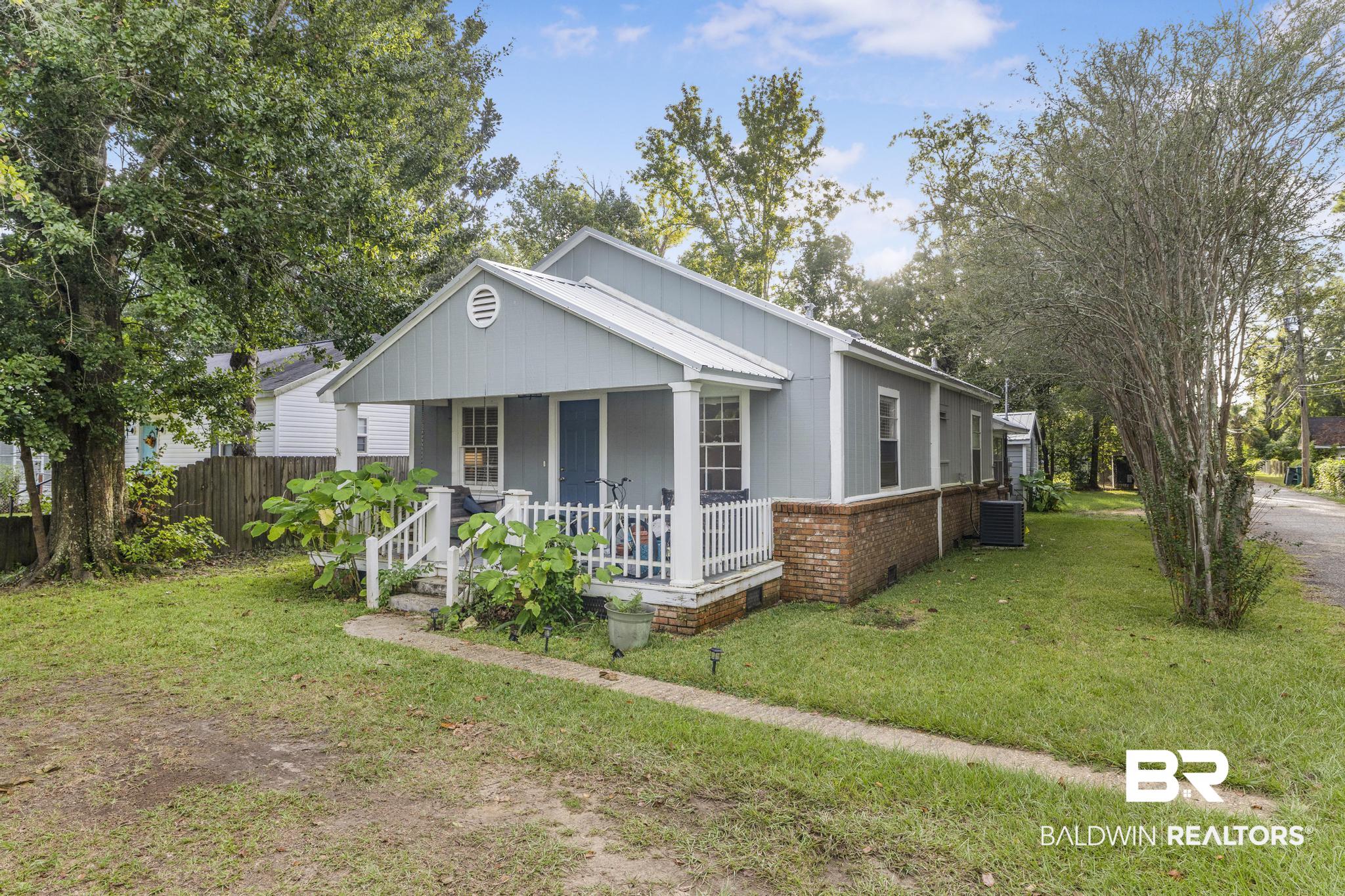 405 North Pine Street Foley, AL 36535 - Photo 2 of 33 Bungalow featuring covered porch and brick siding