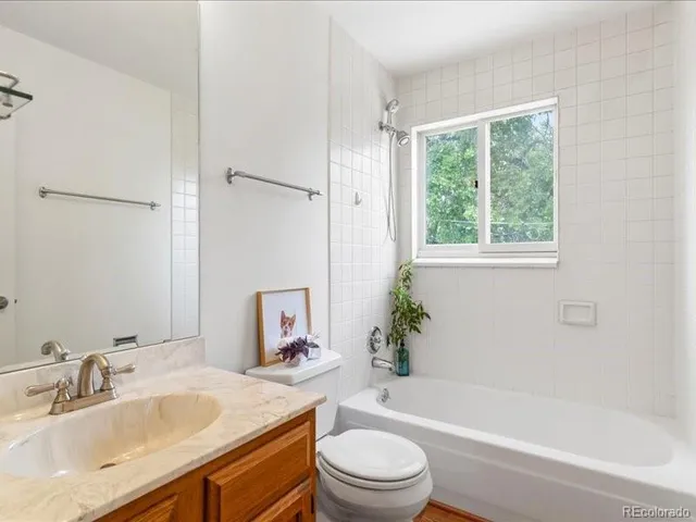 a bathroom with a sink toilet tub and shower