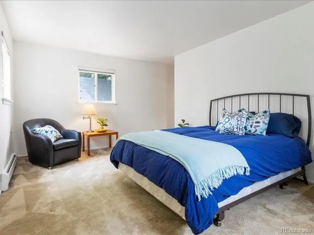 a bedroom with a bed and a couch