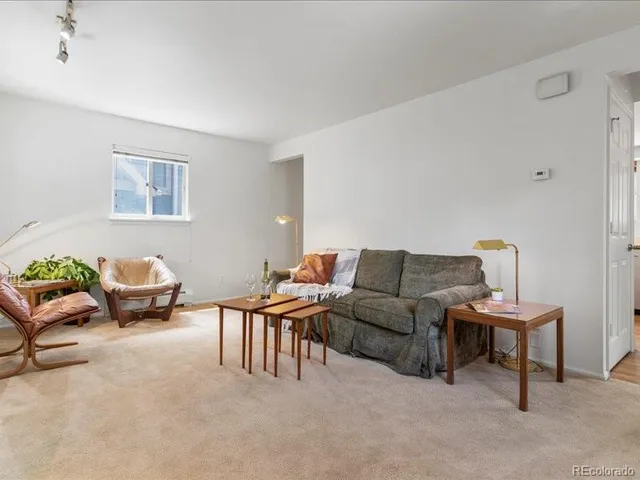 a living room with furniture and a lamp