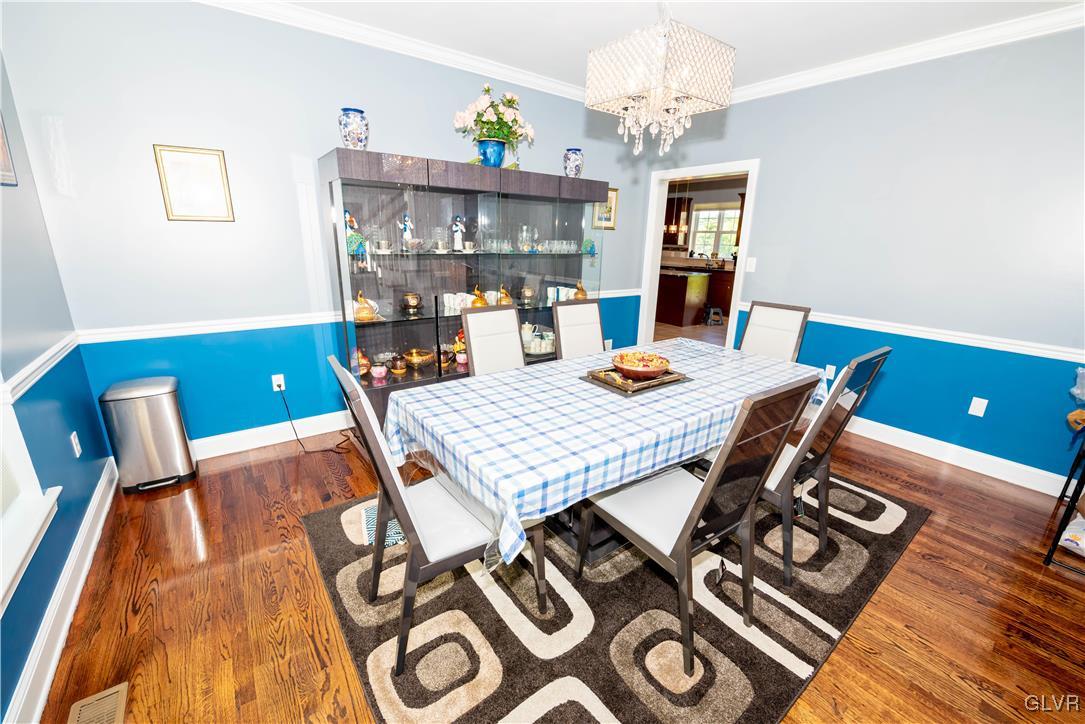 140 Fox Ridge Nazareth, PA 18064 - Photo 3 of 24 a view of a dining room with furniture a chandelier and wooden floor